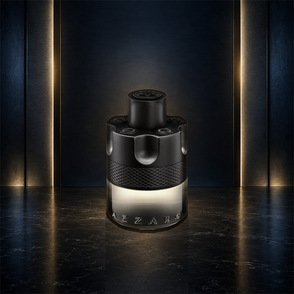 Azzaro The Most Wanted Eau de Toilette Intense 3.4 oz bottle on a navy, gunmetal, and gold studio background